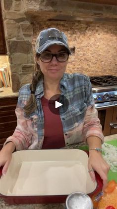 a woman sitting at a table with a tray of food in front of her on the counter