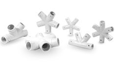 several white plastic pipes and fittings on a white background