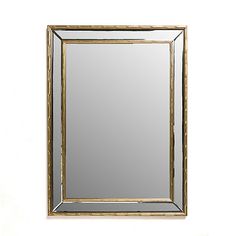 a gold framed mirror on a white wall