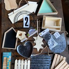 the table is covered with assorted items such as wood, paper and other crafting supplies