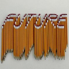 a group of pencils that are lined up together