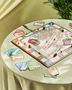 a board game sitting on top of a table next to a potted plant