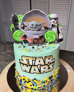 a star wars themed birthday cake with candy and candies on the top, decorated in green icing