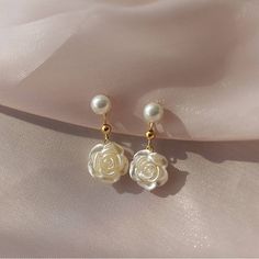 Pure camellia pearl dangle earrings Inspired by the camellia, these camellia earrings not only look pleasing but also have a lot of meaning. The whole flower of dangle pearl earrings is made of pure white acrylic and looks very elegant and charming. Camellia flower earrings represent pure love, adoration, and longing and are the perfect gift for your partner. Eternal love symbol - camellia pearl flower earrings Usually, the layering petals represent the woman and the calyx the man. Unlike other flowers, the calyx always falls off with the petals. Therefore, camellia pearl flower earrings are suitable to express endless love. The layered nature of the camellia dangle pearl earrings also makes them ideal as a statement piece of jewelry. Pearl dangling earrings with allergy-free pins Medical Pearl Flower Earrings, Bridesmaid Gifts Earrings, Willy Wonka, Jewelry Lookbook, Pearl Earrings Dangle, Chic Jewelry, Pearl Flower, Girly Jewelry