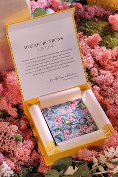 an open box with some flowers on the ground