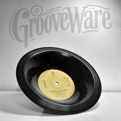 an old record with the word groveware on it is sitting in front of a white wall