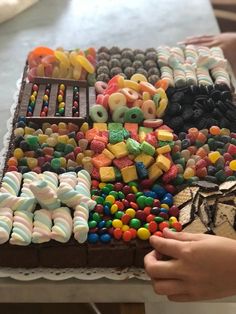 a cake with many different types of candy on it