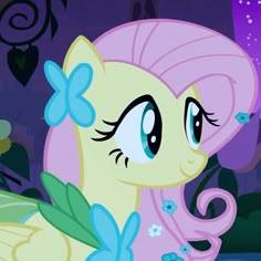 the pinkie pony has blue flowers on it's tail and is looking at something