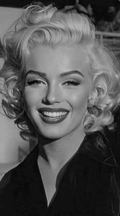 a black and white photo of a woman smiling