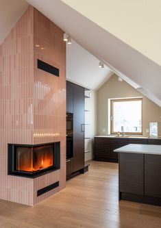 an open kitchen with a fireplace in the center