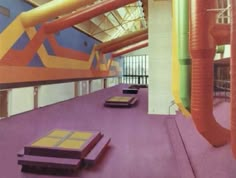 an indoor area with colorful walls and flooring