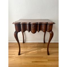 a wooden table with three drawers on it