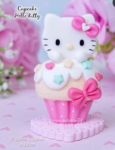 a hello kitty cupcake with pink and white frosting