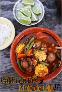 the meal is prepared and ready to be eaten on the table with rice, corn, and limes