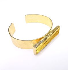 Material   Wrist strap : Brass  Blank : Zinc alloy Nickel Free and Lead Free Color: Shinny Gold Wristband width: 15 mm Blank Size :  50x10mm Rectangle blank inner depth : 3 mm To see other all Gold Bracelet Blanks please click below https://www.etsy.com/shop/AZsupplies/search?search_query=bracelet+blank+gold&order=date_desc&view_type=list&ref=shop_search To see other all Gold Ring Blanks please click below https://www.etsy.com/shop/AZsupplies/search?search_query=nice+gold+ring+blank&order=date_desc&view_type=list&ref=shop_search To see other all Gold Plated Pendant Blanks please click below https://www.etsy.com/shop/AZsupplies/search?search_query=gold+necklace+blank&order=date_desc&view_type=list&ref=shop_search To see other all Silver Bracelet Blanks please click below https://www.etsy.co Bracelet Blanks, Bronze Bracelets, Gold Armband, Dry Flower, Brass Bracelet, Rose Gold Bracelet, Copper Bracelet, Raw Brass, Antique Copper