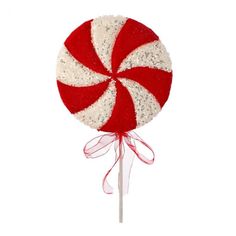 a red and white lollipop on a stick