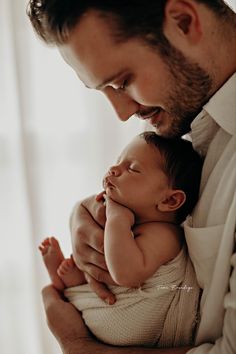 a man holding a baby in his arms