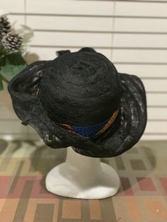 For those fun days out add a Zulu lace hat to your wardrobe. This lace crown has six different looks. The hat was inspired by my friendship with the Zulu women from Johasurburgh, from South Africa. Turn the hat to fit your mood. Every turn is a different expression. The kente cloth band is removable. This is a black lace hat with kente cloth. There is lace strings inside to give you the proper fit. This hat is pack friendly. This is a nice and simple statement that will turn heads. Great for fes Black Fedora Sun Hat For Kentucky Derby, Black Brimmed Boater Hat For Church, Black Brimmed Hats For Church, Black Brimmed Church Hat, Black Wide Brim Boater Hat For Church, Black Fitted Bucket Hat, Black Brimmed Sun Hat For Kentucky Derby, Black Wide Brim Hat For Kentucky Derby, Black Brimmed Hat For Races