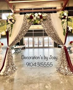 the entrance to an event decorated with flowers and sequins