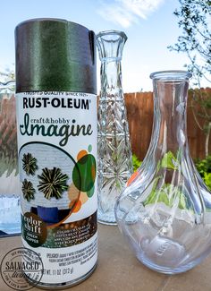 two glass vases sitting next to each other on a table