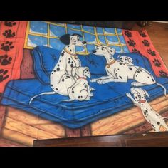 a drawing of three dalmatian dogs on a bed