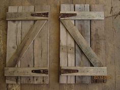 two wooden doors with metal latches on them