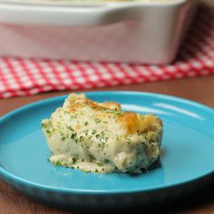 a blue plate topped with food next to a casserole dish