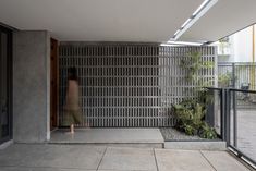 a woman is standing in an open courtyard