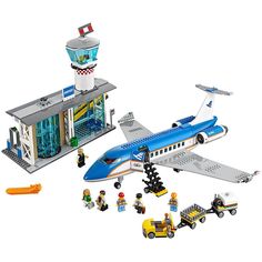 a lego airport scene with an airplane and some people in front of the plane,