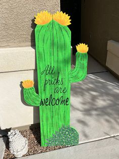 a wooden sign that says, he pricks are welcome with a cactus on it