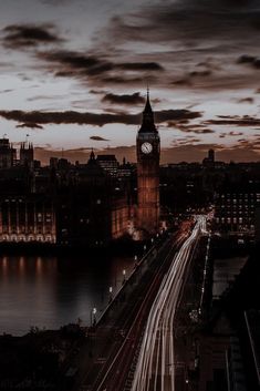 the big ben clock tower towering over the city of london at night with long exposure