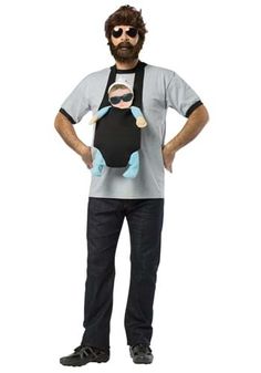 a man with a beard and glasses is holding a stuffed animal in his arms while wearing overalls