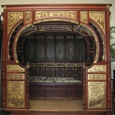 an ornately decorated wooden stage with carved wood panels