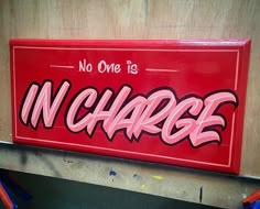 a red sign that says no one is in charge