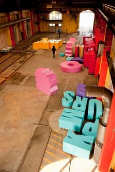 colorfully painted letters are arranged in the middle of an empty building