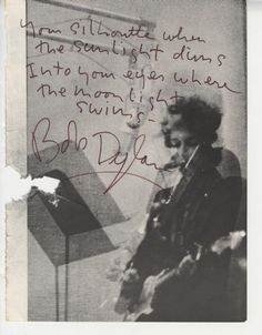 an old photo with writing on it and a woman sitting in front of a lamp