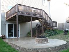 an outdoor patio with stairs and fire pit