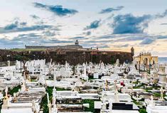 many white headstones are in a cemetery