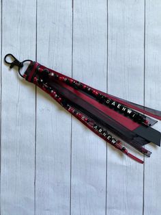 two red and black skis with the words pawn written on them sitting on a white wooden surface