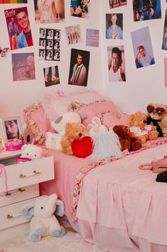 there are many pictures on the wall above the bed and in front of the child's bed