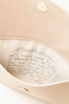 the inside of a purse with writing on it's front pocket and bottom flap