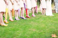 a group of women standing next to each other holding umbrellas in front of them