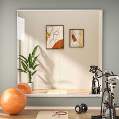 an exercise room is shown with two exercise balls and a gym equipment on the floor