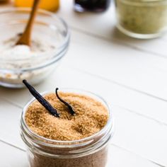 a jar filled with sand and spices on top of a table