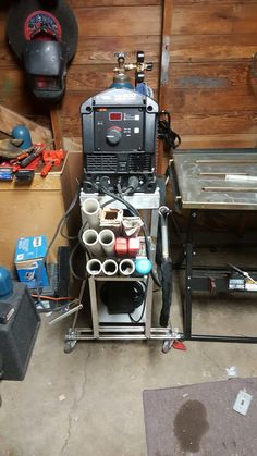 a machine is sitting in the middle of a workbench with tools on it