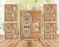 four wooden cards with footprints and the words happy father's day to the dad