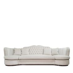 a white couch sitting on top of a wooden floor