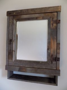 an old wooden mirror hanging on the wall