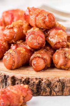 the food is ready to be eaten on the wooden platter with other foods in the background