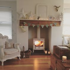 a living room filled with furniture and a fire place in the middle of the room